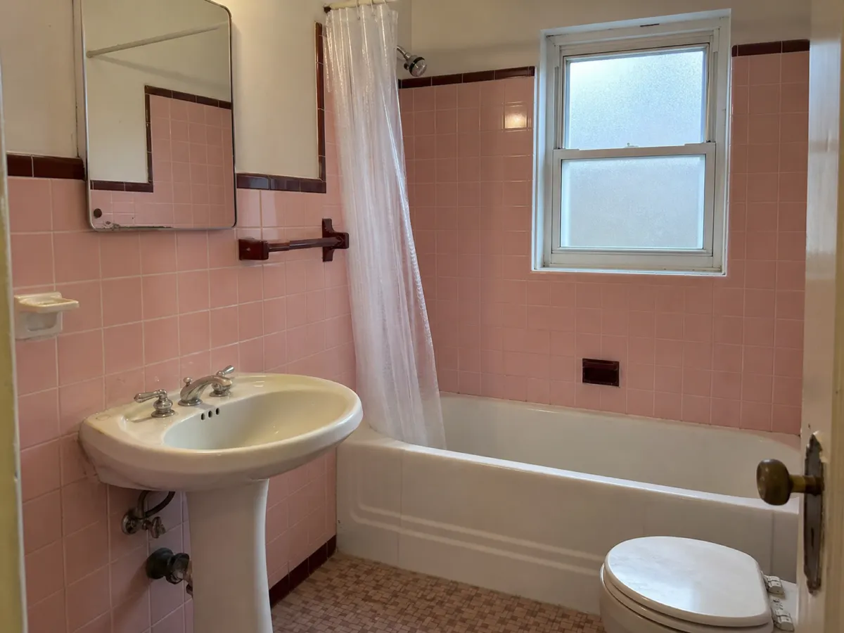 Old bathroom remodeled with new tiles, vanity and shower